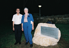 Particle Physics Department Head Prof. Itzhak Tserruya and Dr. Eugenia Klein next to the plaque